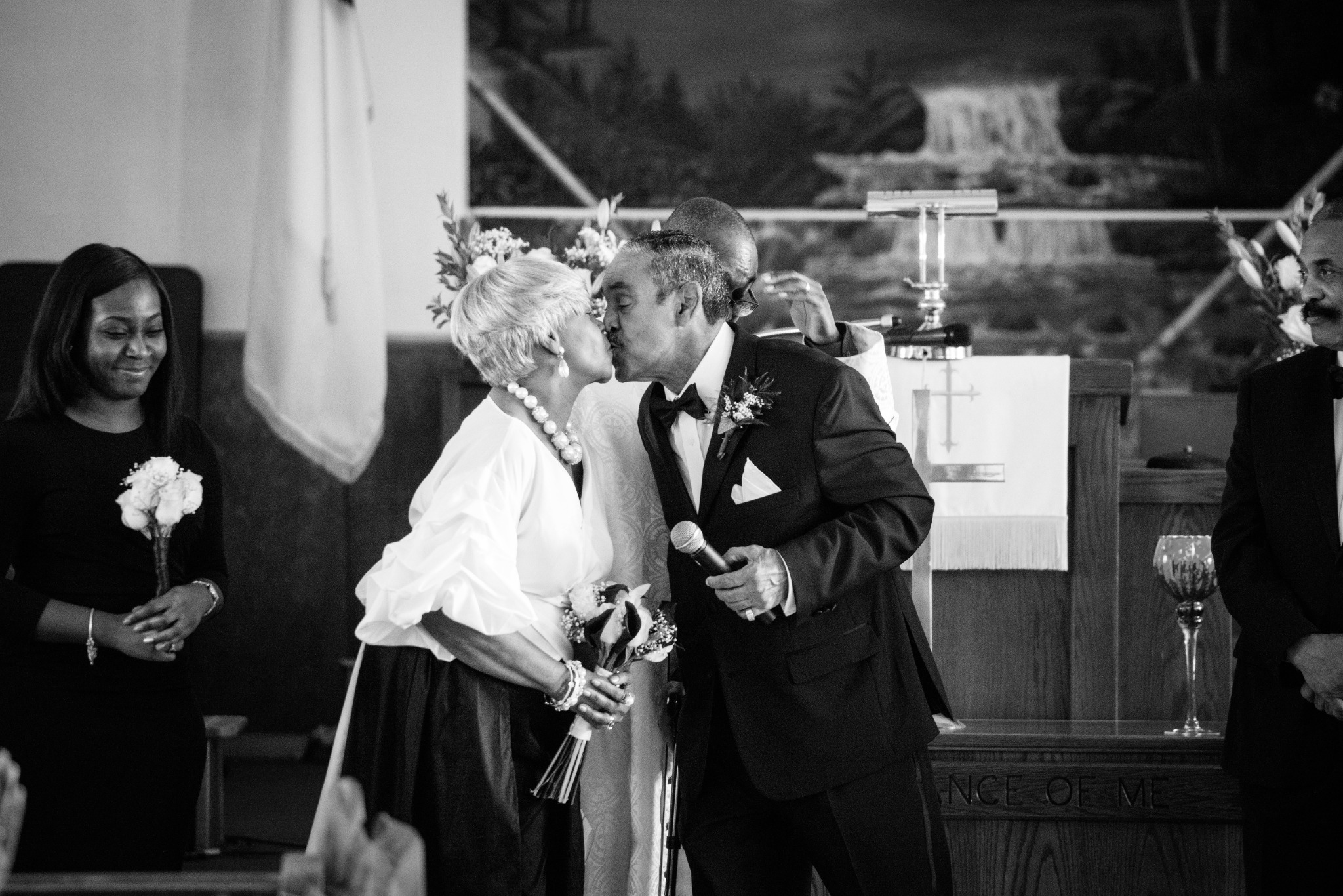 Newlyweds sharing a kiss during their intimate wedding ceremony